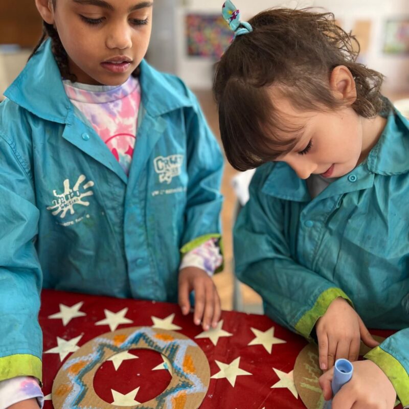 Group of children collaborating on a themed art project