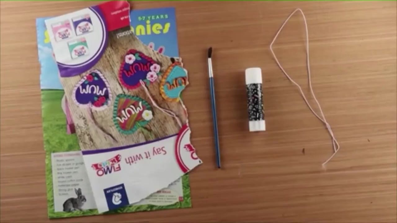 Strips of colourful magazine paper laid out ready for rolling.