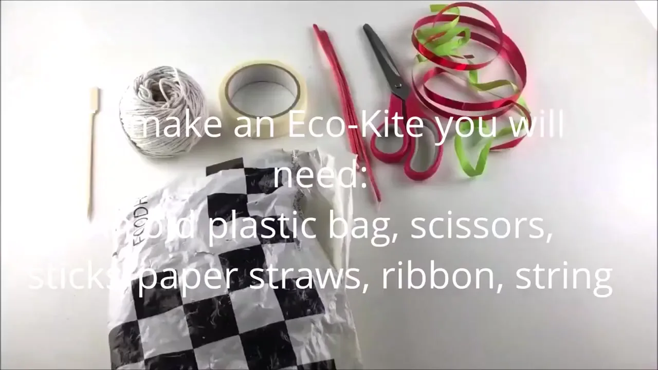 Craft materials used to make a sustainable kite, including a plastic bag, tape, and paper straws
