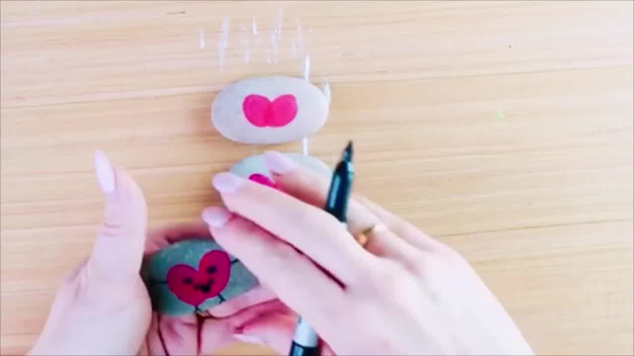 Brightly painted kindness pebbles with uplifting words and designs, ready to be hidden outdoors for others to discover and enjoy.