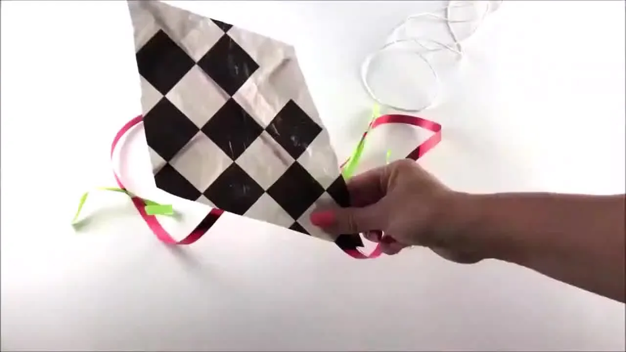 Close-up of a colourful eco-friendly kite created using plastic bag and string