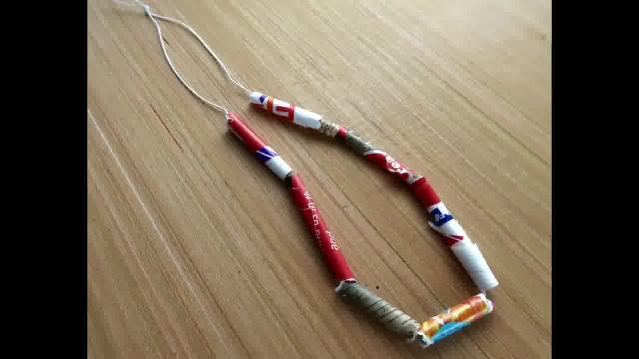 A completed bracelet made from vibrant, handmade paper beads
