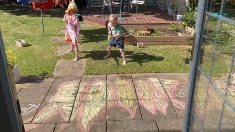 Children using water pistols to put out a chalk fire – a fun way to keep kids cool in hot weather through creative outdoor play