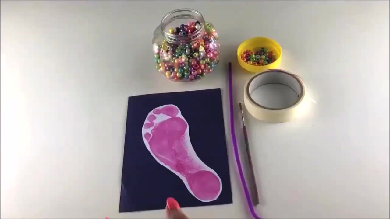 Cut-out footprints glued to backing paper – footprints mounted on colourful card, ready for flip flop straps to be added.