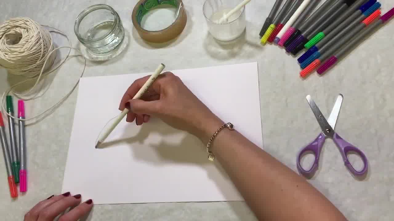 Decorating a cardboard superhero mask with bright colours