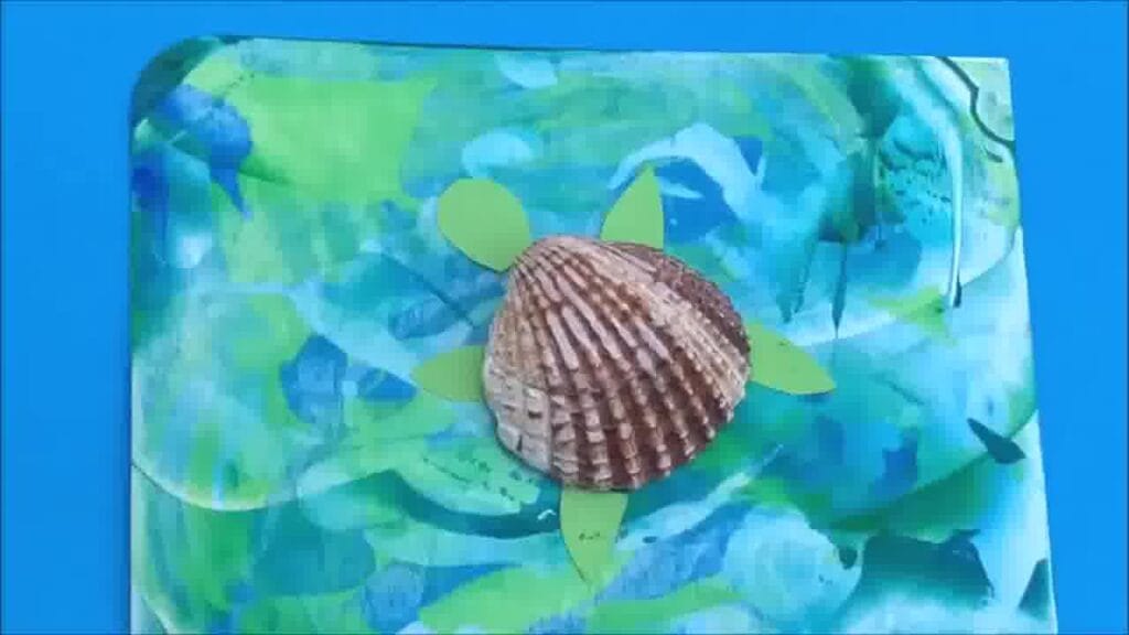 Scrape art turtle assembled with colourful shell and smiling face.