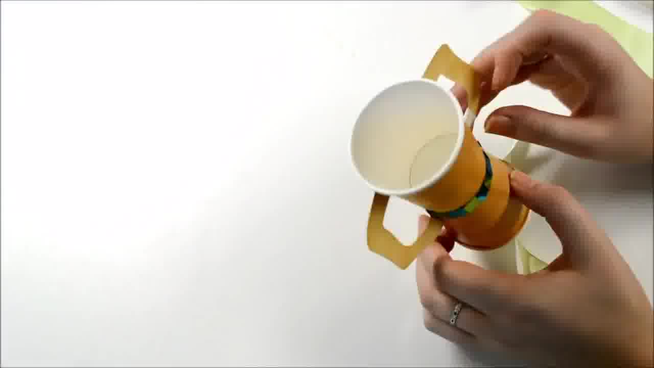 holding a crafty DIY trophy from The Creation Station challenge