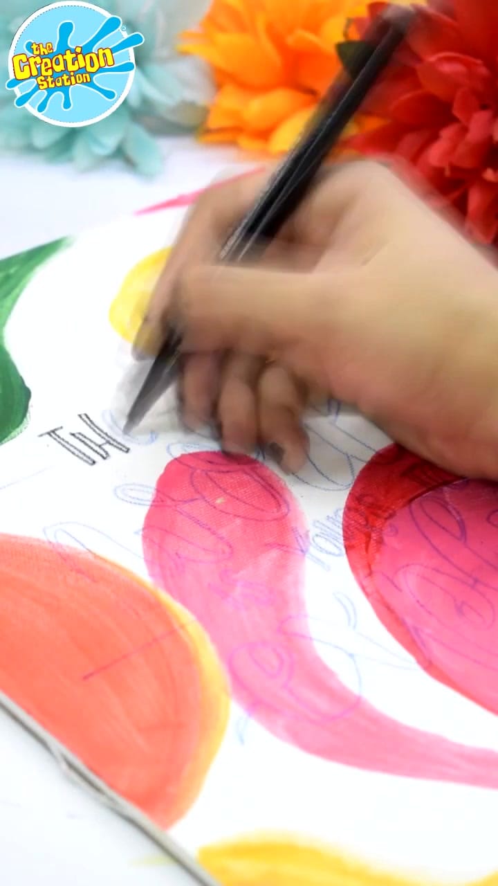 Close-up of a hand holding a calligraphy pen at an angle, ready to begin writing.