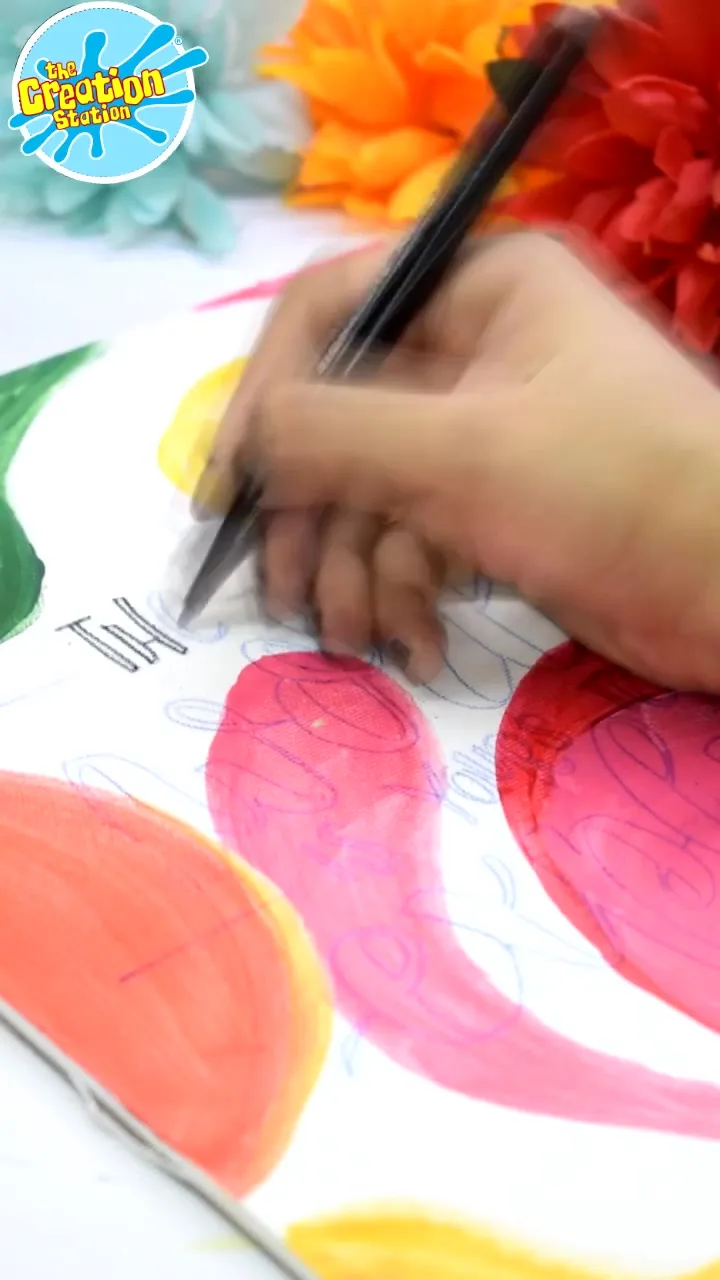 Close-up of a hand holding a calligraphy pen at an angle, ready to begin writing.