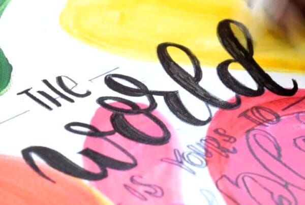 Calligraphy pen creating elegant, flowing letters on paper using smooth strokes