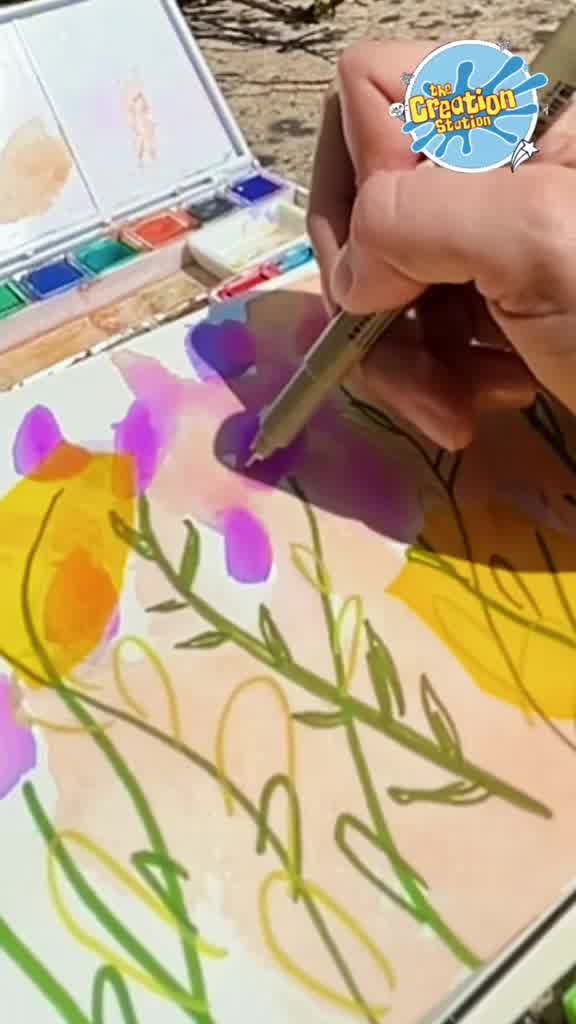 Purple watercolour pen being used to create delicate lavender flower shapes along the stems