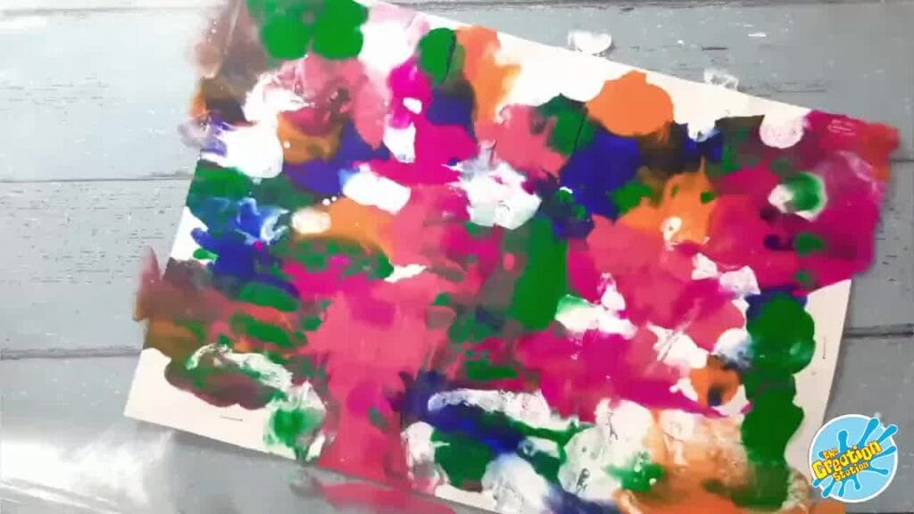 Completed pour art canvas with vibrant, swirling abstract patterns