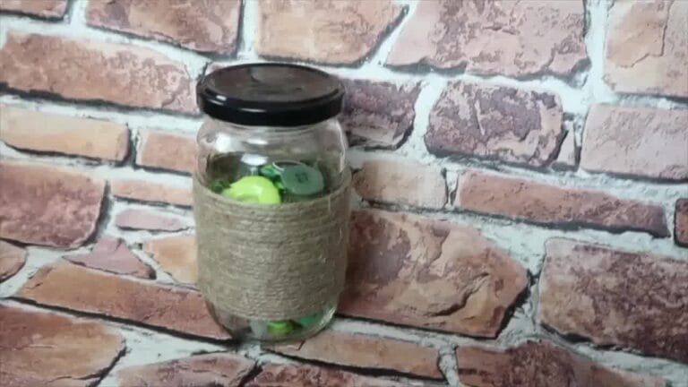 Completed jar decorated with string and embellishments, ready to be used as a vase or decorative piece