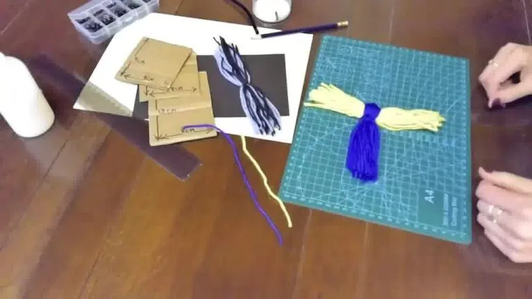 Yarn being wrapped or tied to shape the head section of the bird, forming a rounded top