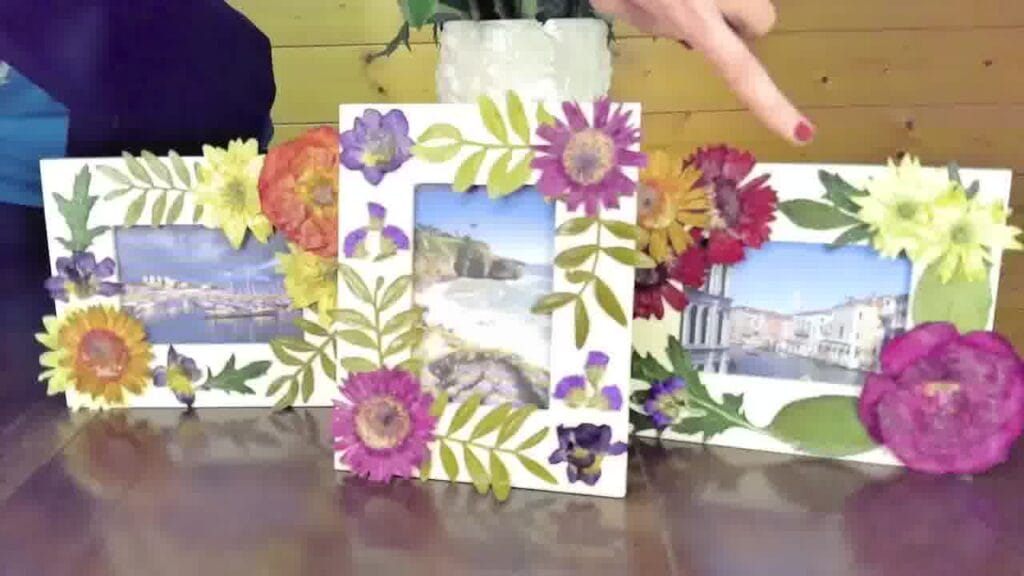 Completed photo frame decorated with colorful pressed flowers around the edges, showcasing a handmade floral design